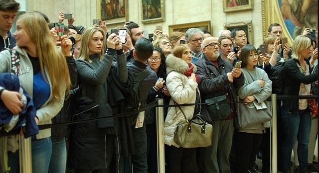 In Paris, the Louvre Museum displays a full house and represses tourists